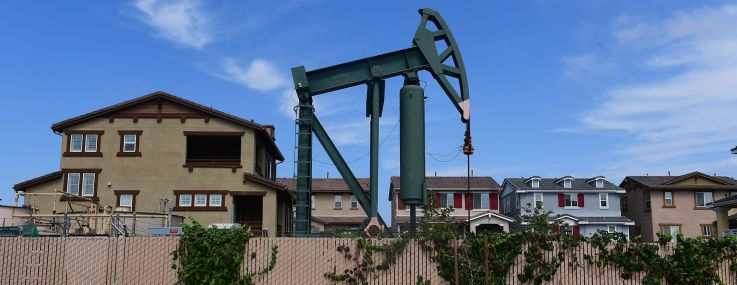 A pumpjack stands out among homes in residential Signal Hill, south of Los Angeles, Calif.