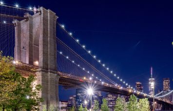 NEW YORK, NEW YORK - AUGUST 23: A view of the Brooklyn Bridge with the One World Trade Center in the back as part of the downtown Manhattan skyline as seen from Brooklyn Bridge Park on August 23, 2022 in New York City.