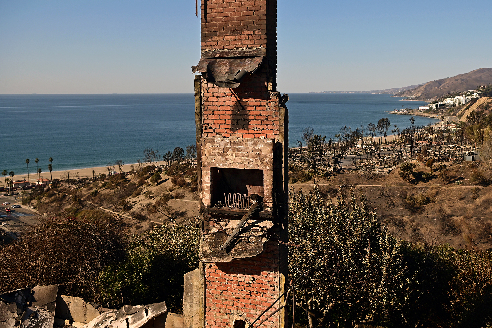 A charred chimney remains standing amid the remains of a house destroyed in the Palisades Fire.