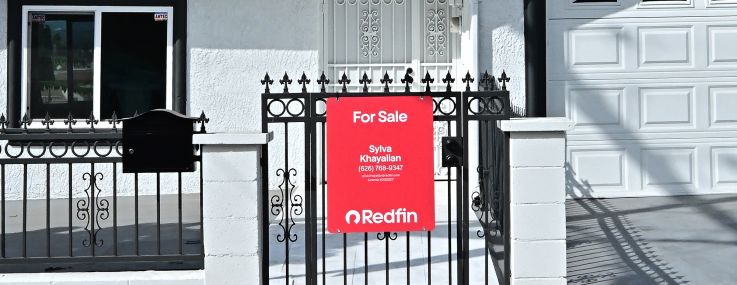 A 'for sale' sign is seen on a house in Monterey Park, Calif.