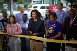 Mayor Muriel Bowser, center, participates in a ribbon cutting event in September 2025 inside the Washington Center building in Northwest Washington.