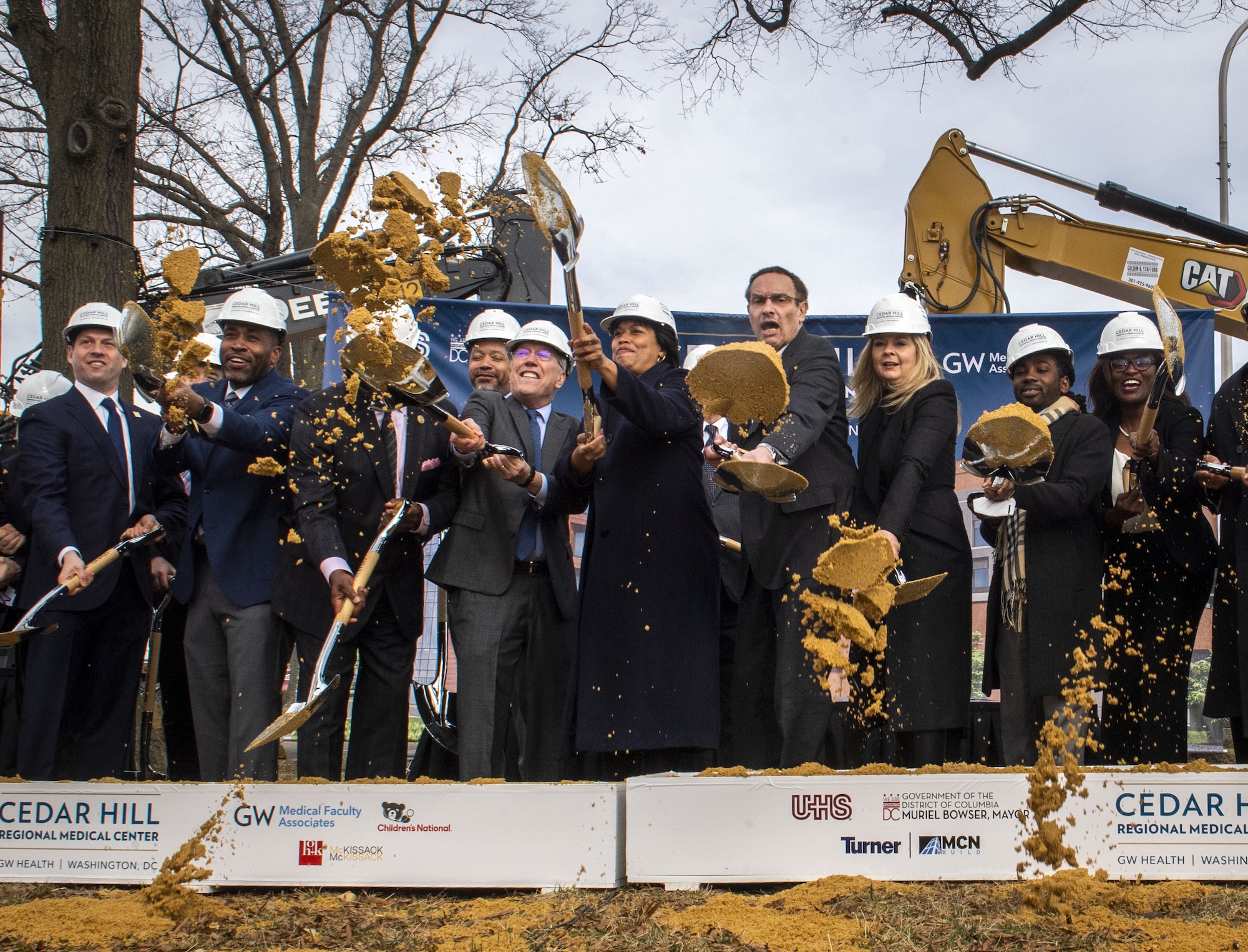 Mayor Muriel Bowser, center, ceremonially breaks ground with executes from Universal Health Services, George Washington University, Children's National Hospital, at the name reveal event of the New Hospital at St Elizabeths East Campus in Washington, D.C.