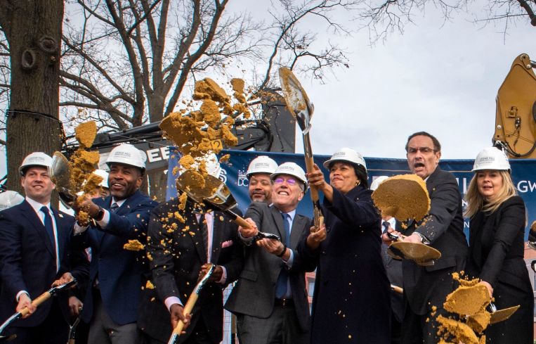 Mayor Muriel Bowser, center, ceremonially breaks ground with executes from Universal Health Services, George Washington University, Children's National Hospital, at the name reveal event of the New Hospital at St Elizabeths East Campus in Washington, D.C.