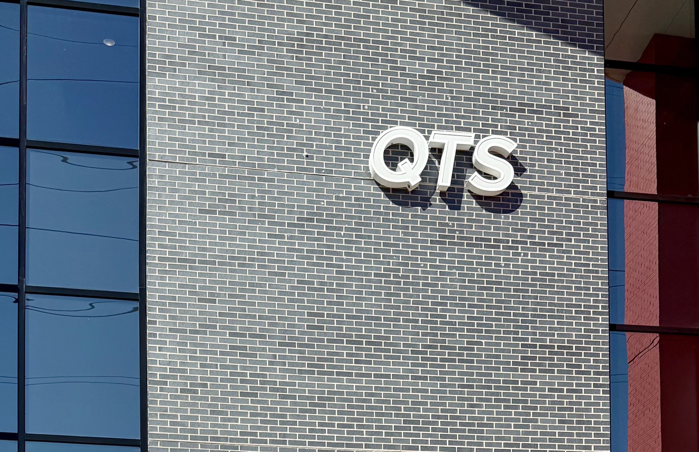 The QTS logo on a building.