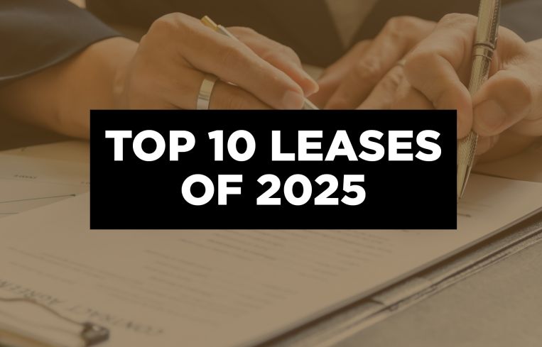 A photo of someone signing a lease with a placard that reads Top 10 Leases of 2025.