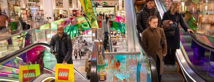 Holiday shoppers navigate Saks Fifth Avenue on Christmas Eve in New York City.