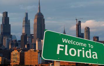A Welcome to Florida sign in front of the New York City skyline.