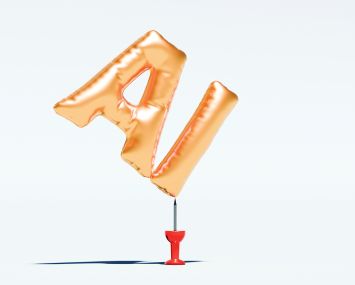 Two balloons shaped like the letters "A" and "I" float above a small pin.