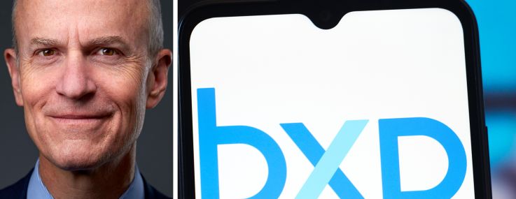 Chairman and CEO Owen Thomas and a mobile phone displaying the BXP logo.