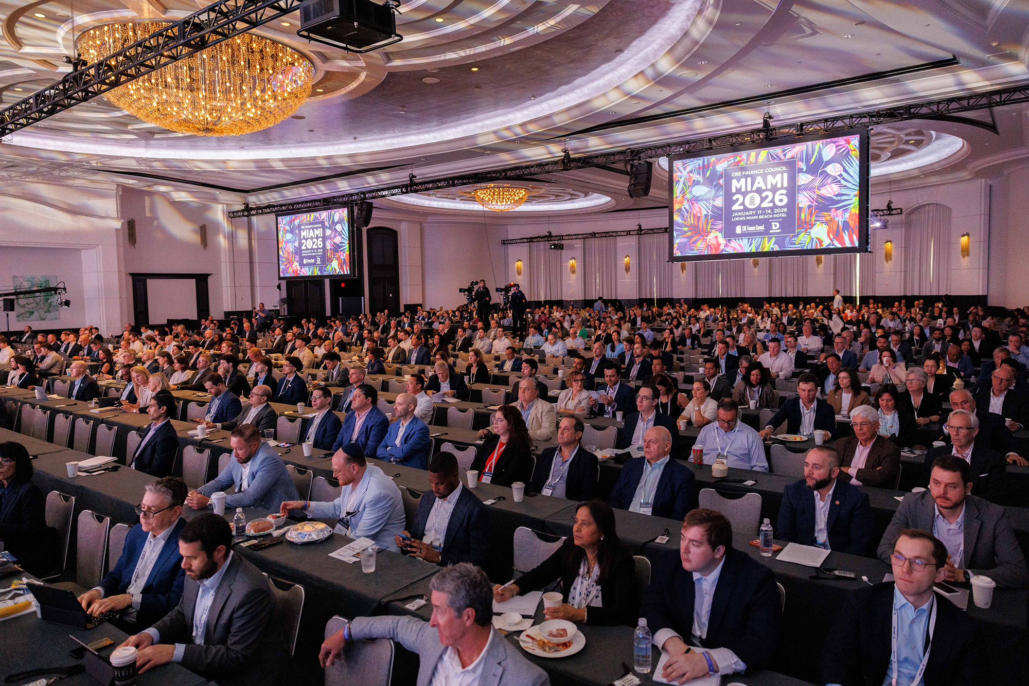 Attendees listen to a panel at CREFC in Miami.