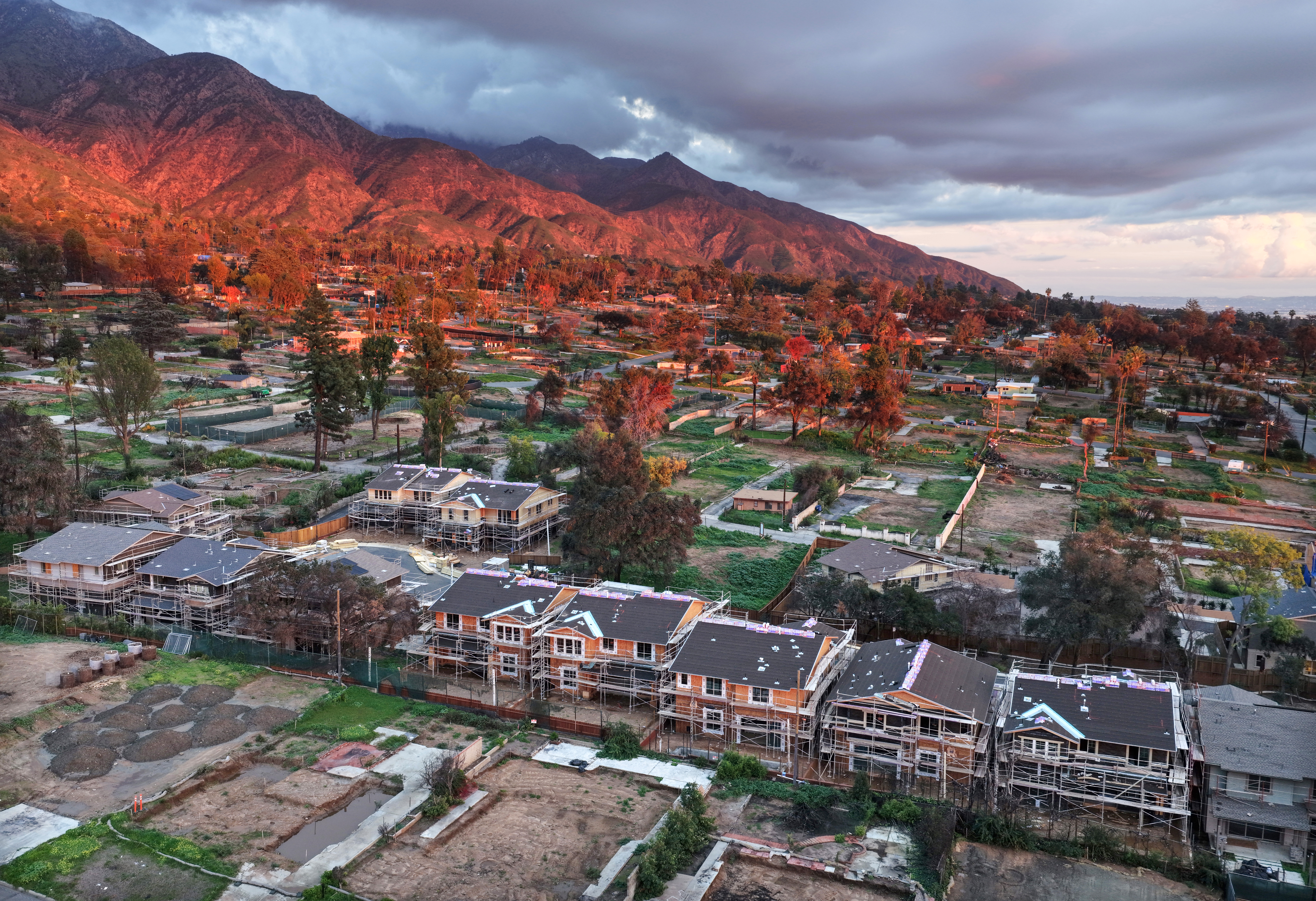 An aerial view of construction of 16 new homes at a planned community amid cleared lots where homes were destroyed by the Eaton Fire on January 5, 2026 in Altadena.