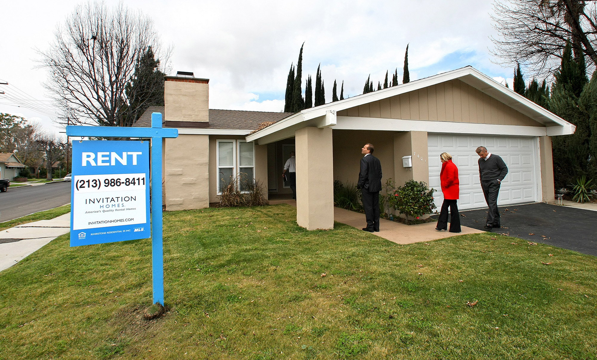 Officials from Invitation Homes, tour a home on Casaba Avenue in Canoga Park, Calif.