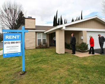 Officials from Invitation Homes, tour a home on Casaba Avenue in Canoga Park, Calif.
