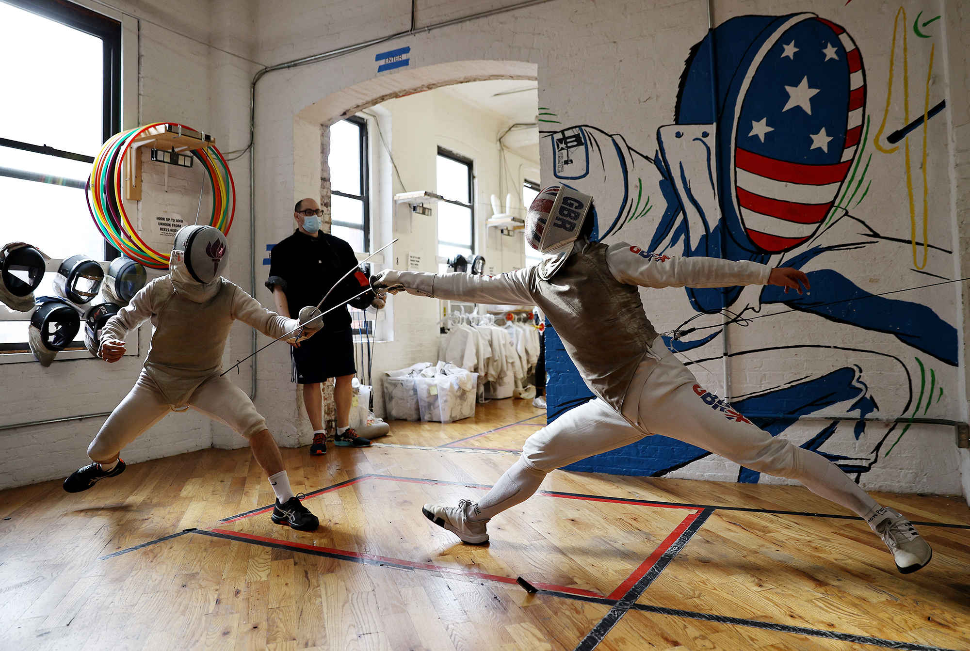 Great Britain Olympic fencer Marcus Mepstead trains as his coach Dan Kellner looks on at the Brooklyn Bridge Fencing Club.