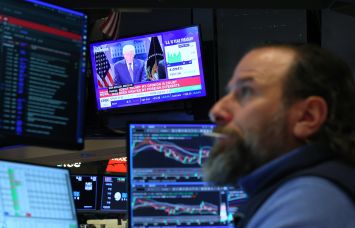 President Donald Trump's press conference on the Supreme Court's tariff decision is displayed on a television on the New York Stock Exchange.