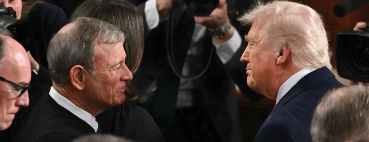 Supreme Court Chief Justice John Roberts (left) shakes hands with President Donald Trump as he arrives to deliver his State of the Union address.