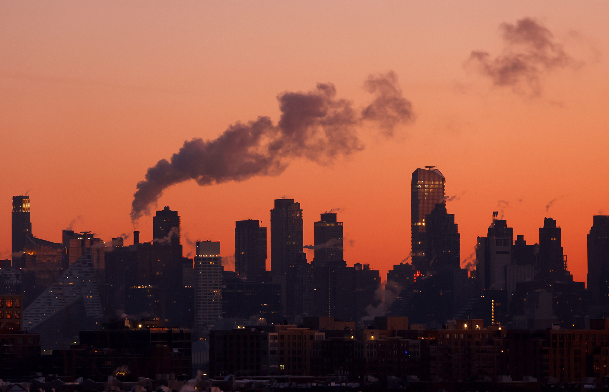 Emissions come out of smoke stacks and buildings in New York City.