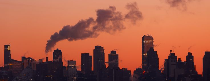 Emissions come out of smoke stacks and buildings in New York City.