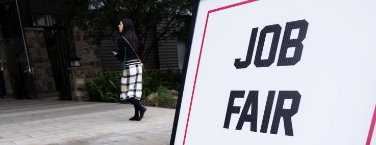 A sign advertises a job fair in Lake Forest, Calif.