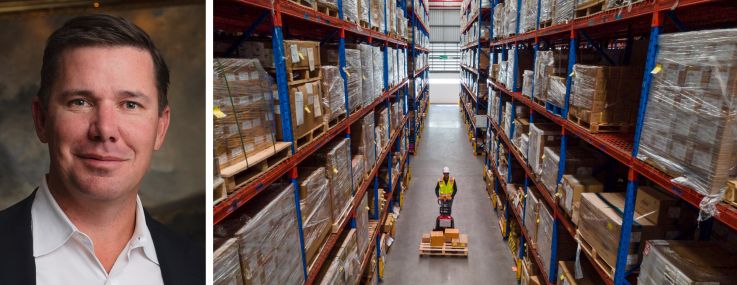 Harbert Management President and CEO Travis Pritchett and a worker moving a palette through a warehouse.