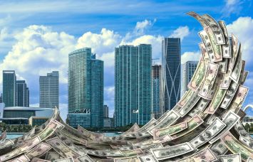 Miami skyline with a wave of dollar bills in front of it.