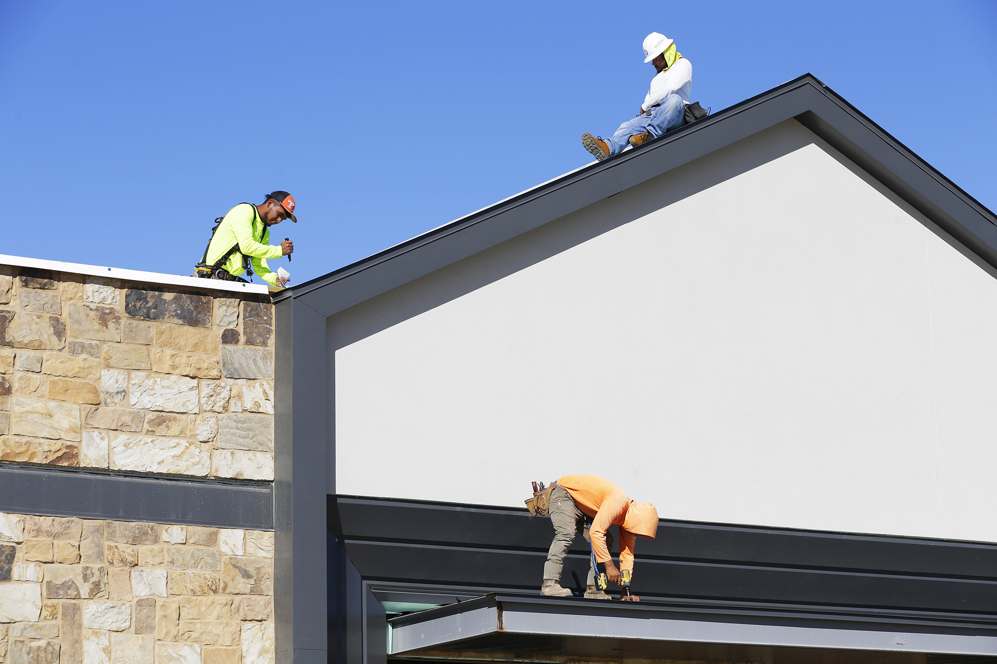 Workers continue construction on the Marcel Gardens shopping center in Fulshear, Texas, outside of Houston in 2024.