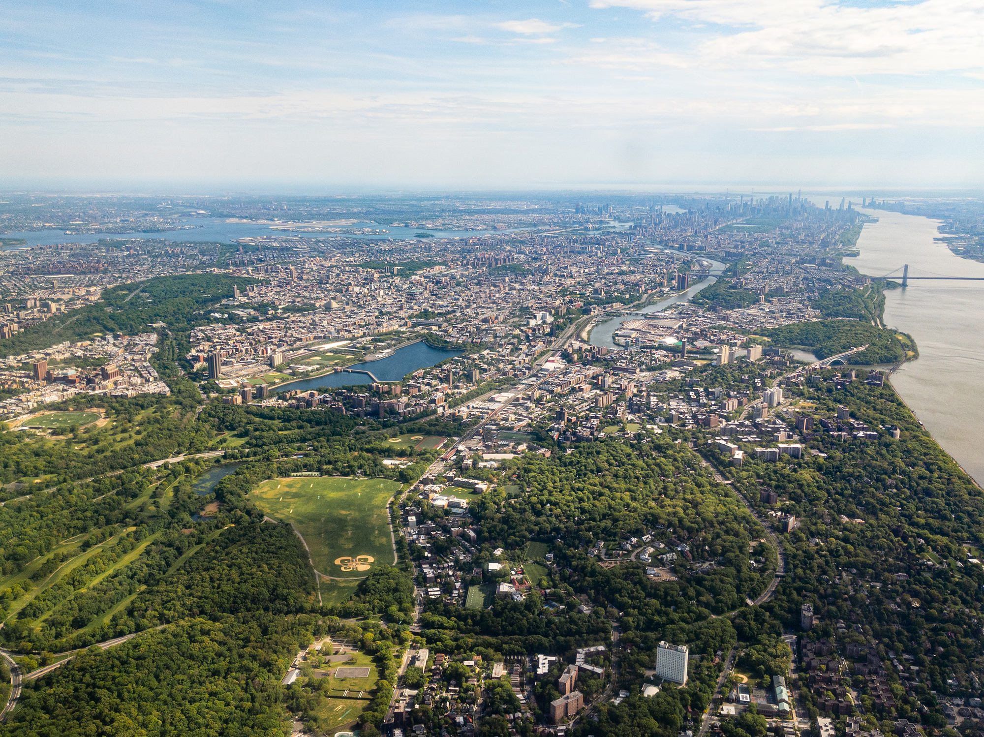 Aerial view of Bronx, New York City with Manhattan and Brooklyn in the distance, facing south.