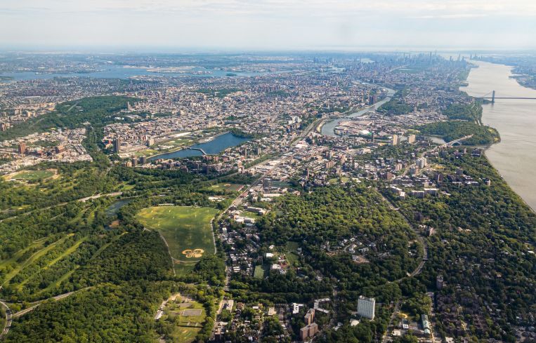 Aerial view of Bronx, New York City with Manhattan and Brooklyn in the distance, facing south.
