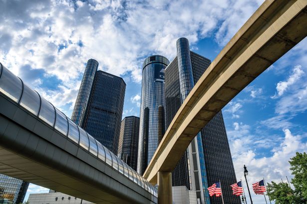 The Renaissance Center framed by a footbridge and the monorail infrastructure in Detroit.