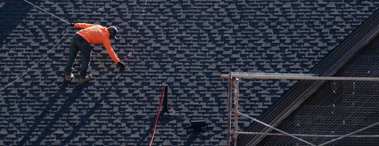 Construction workers rebuild a home in Altadena, Calif.