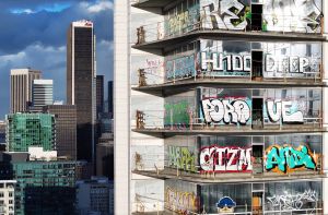 An aerial view of graffiti spray painted by taggers on at least 27 stories of a skyscraper development in Los Angeles.