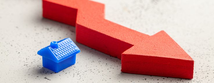 An illustration of a small toy house and red arrow pointing down.