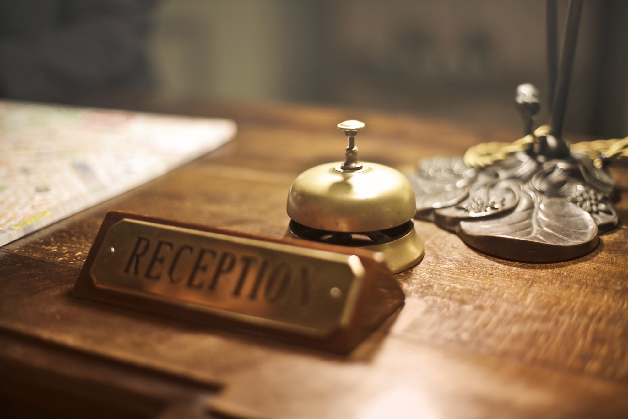 An old-time front desk bell at a reception desk.