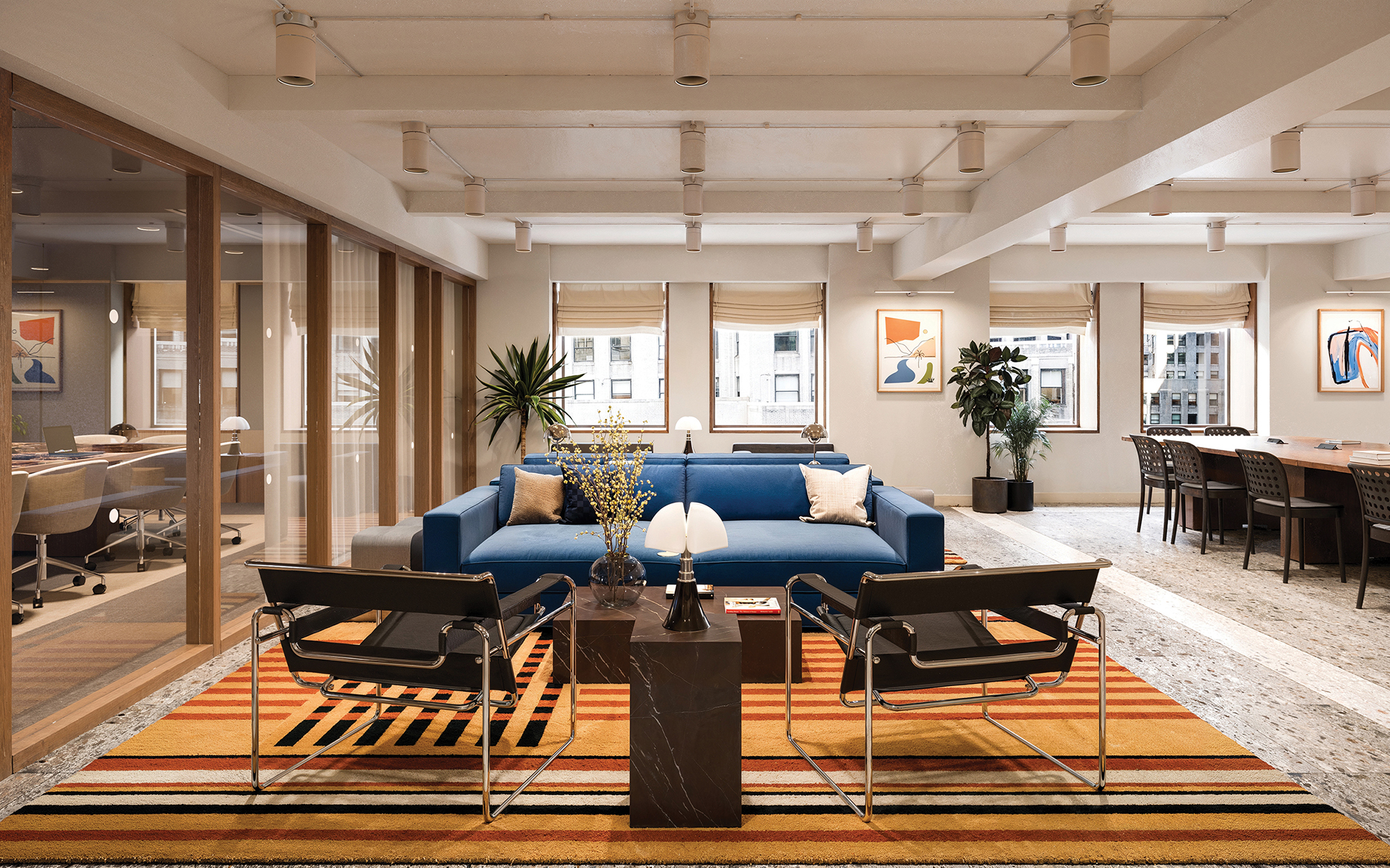 A rendering of a WeWork office's lounge space at 511 5th Avenue, with modern furnishings, white finished ceilings and a line of windows.
