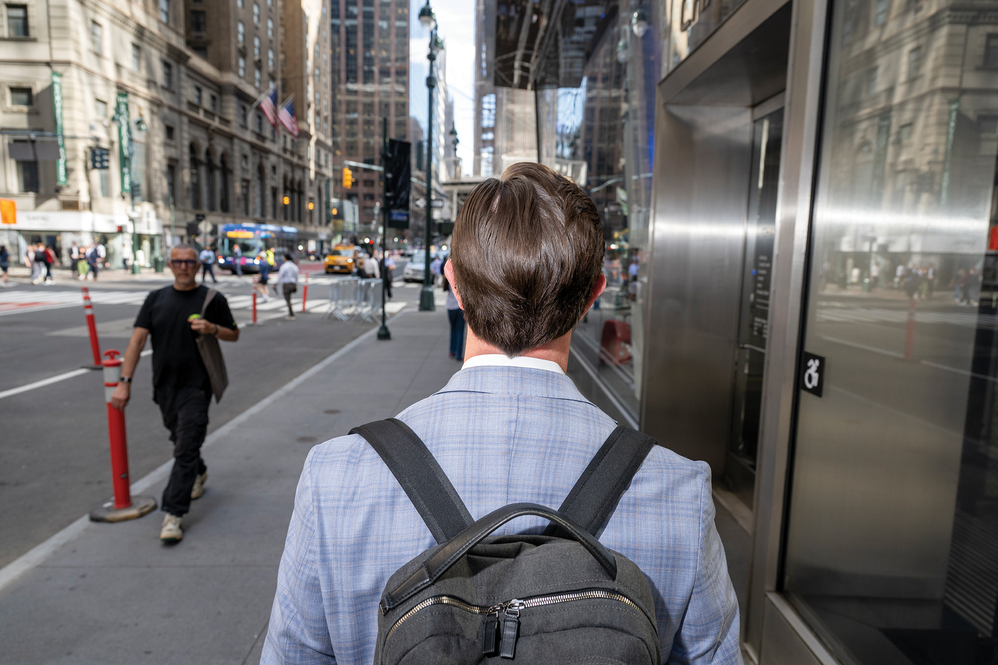 John Lewis, Vice President of Investments at North Bridge walks at a nearby pub after work to have drinks with Eric Conway, Senior Director of Hotel Franchise Finance at Western Alliance, center, and Conor Barry, Vice President at Aareal Bank on June 15, 2026 in Manhattan, New York.
