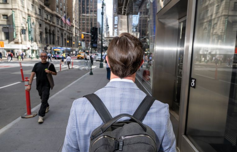 John Lewis, Vice President of Investments at North Bridge walks at a nearby pub after work to have drinks with Eric Conway, Senior Director of Hotel Franchise Finance at Western Alliance, center, and Conor Barry, Vice President at Aareal Bank on June 15, 2026 in Manhattan, New York.
