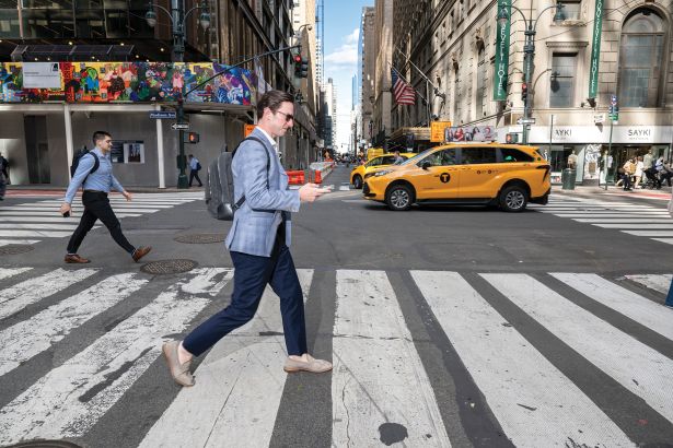 John Lewis, Vice President of Investments at North Bridge walks at a nearby pub after work to have drinks with Eric Conway, Senior Director of Hotel Franchise Finance at Western Alliance, center, and Conor Barry, Vice President at Aareal Bank on June 15, 2026 in Manhattan, New York.