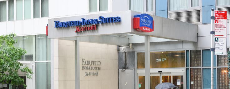 A person walks outside Fairfield Inn & Suites by Marriott at 21 West 37th Street.