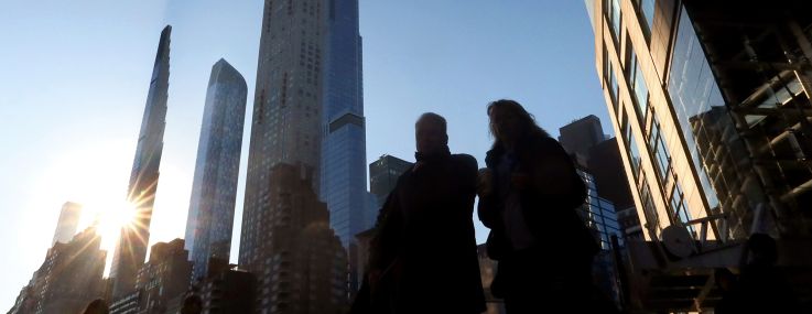 The sun rises behind the Steinway Tower as it casts a shadow along Billionaires' Row in Manhattan.