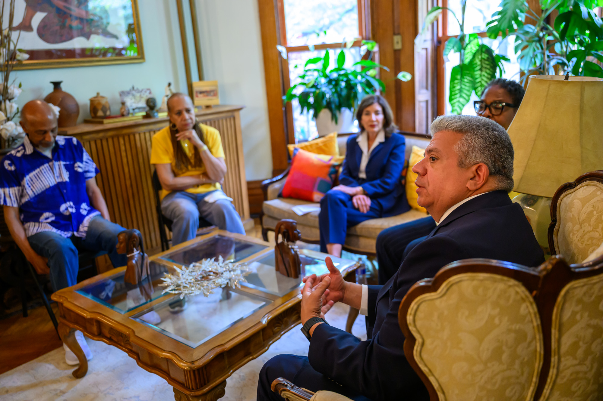Brooklyn District Attorney Eric Gonzalez (right) and Gov. Kathy Hochul (center) meet with Brooklyn homeowners about deed theft on Wednesday.