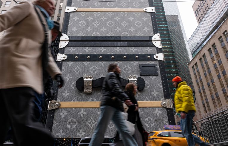 People walk along Fifth Avenue in midtown Manhattan.