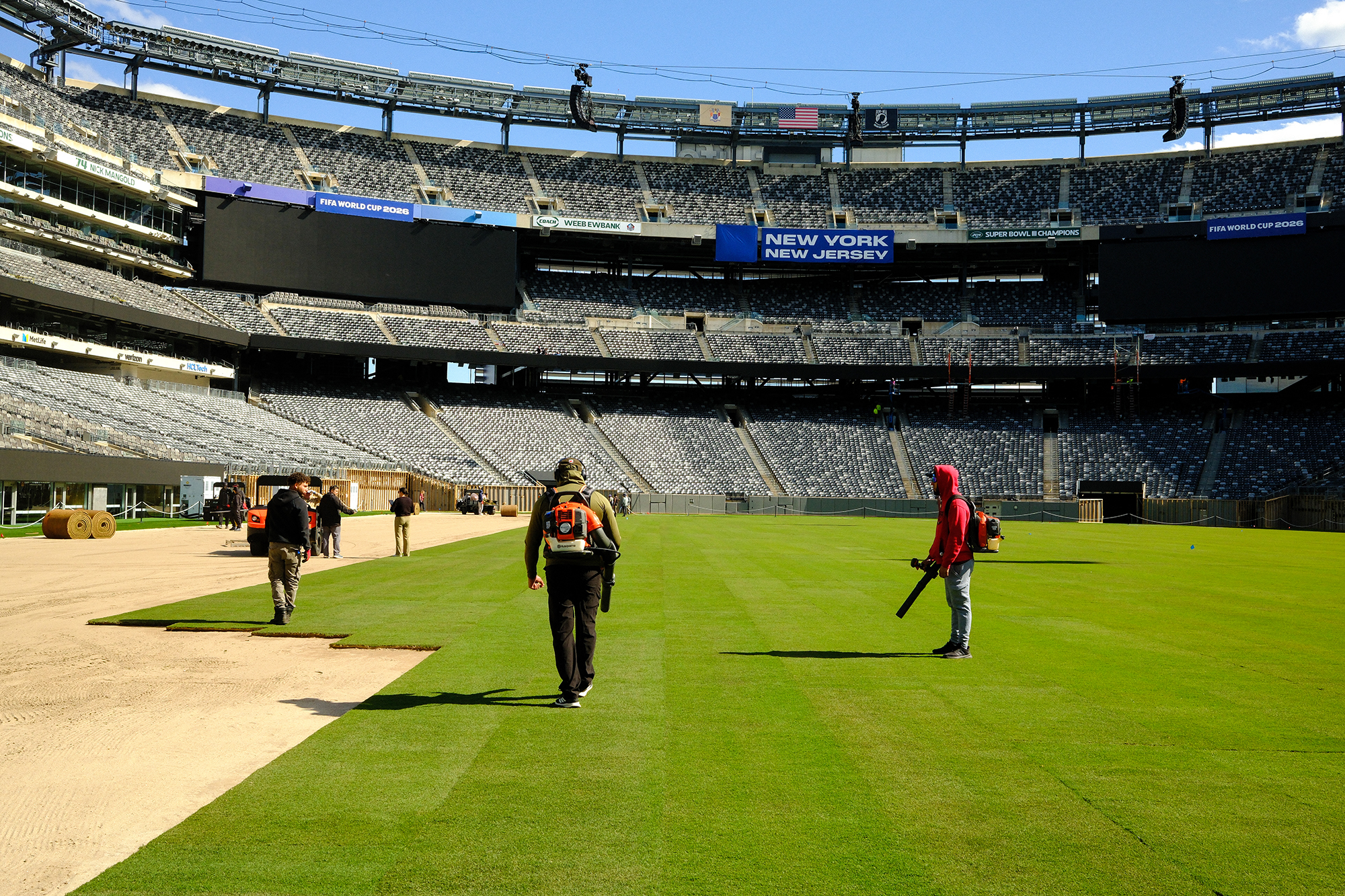 Workers install the pitch at New York New Jersey Stadium (temporarily renamed from MetLife stadium) in East Rutherford, N.J. ahead of the 2026 FIFA World Cup.