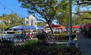 Culver City’s Housing Strategy: Don’t Be L.A. People enjoy an outdoor dining area partially blocking a main boulevard in downtown Culver City, Calif.