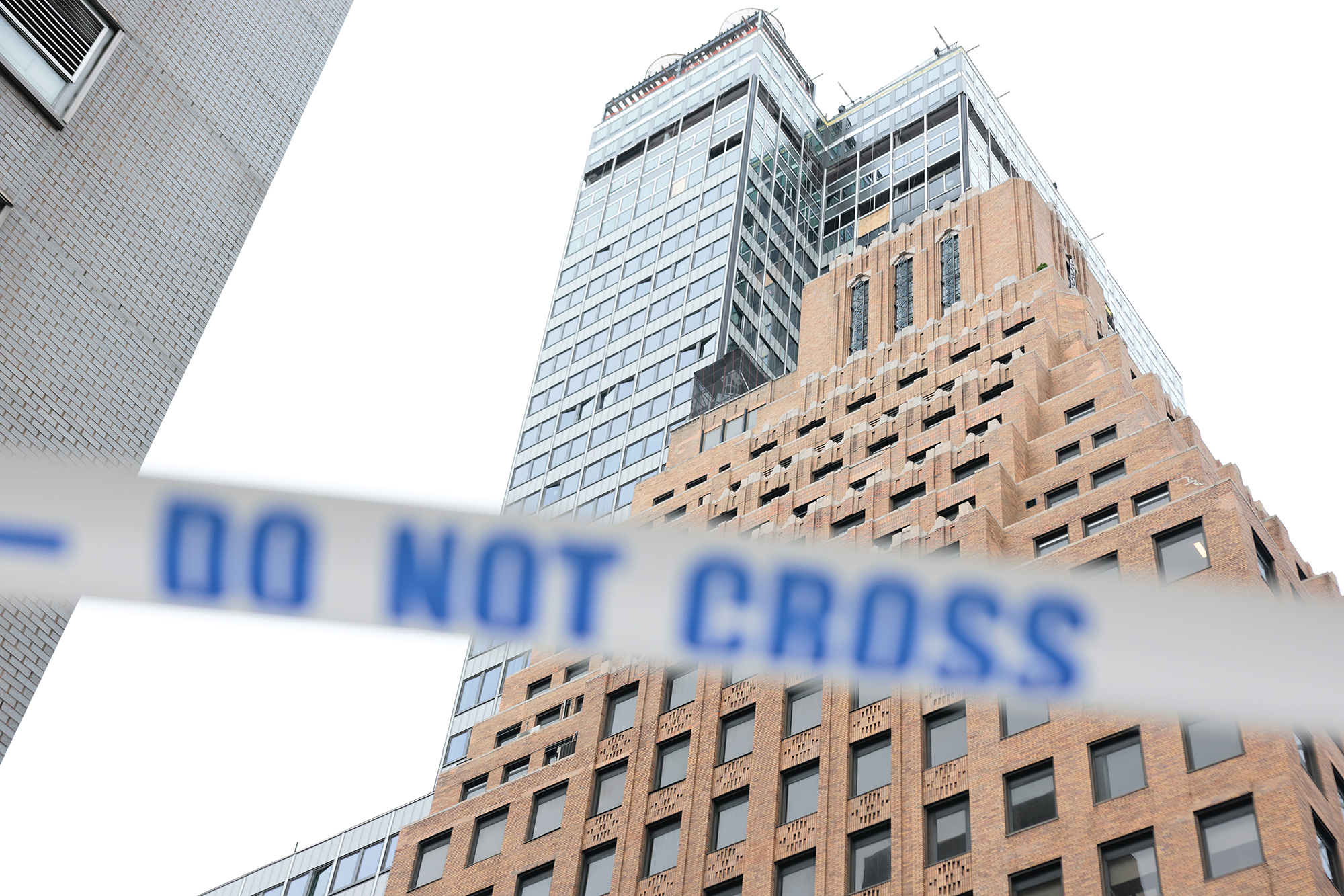 Caution tape blocks the street near the former Pfizer headquarters building after a safety manager reported that a steel beam was compromised on the 21st floor.