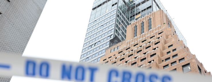 Caution tape blocks the street near the former Pfizer headquarters building after a safety manager reported that a steel beam was compromised on the 21st floor.