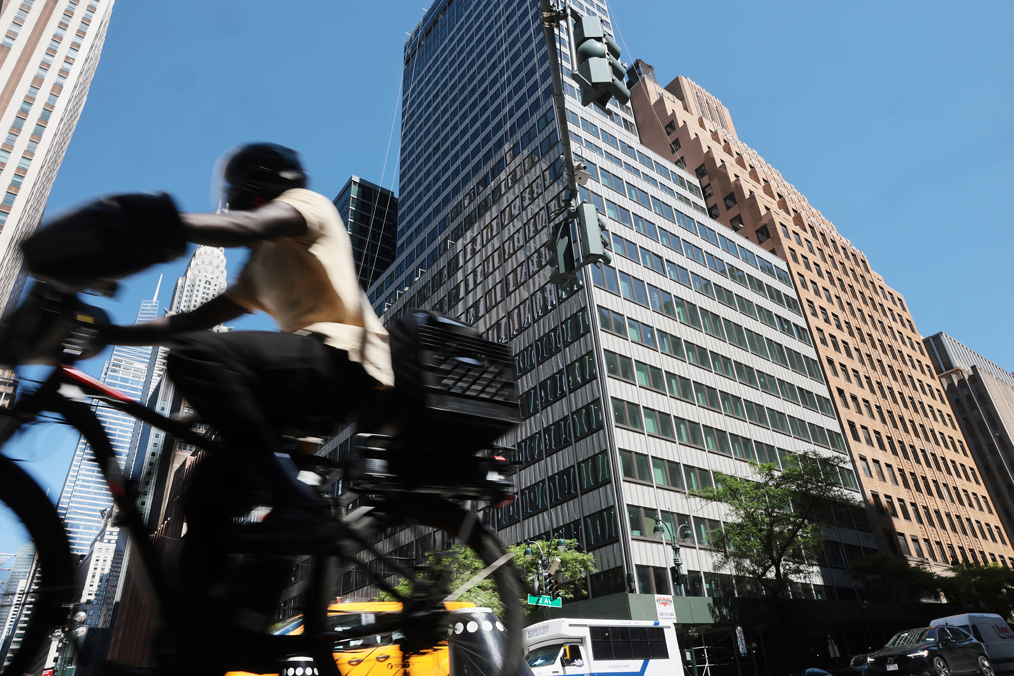 People pass the former Pfizer headquarters building at 235 East 42nd Street.