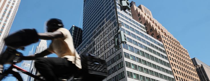 People pass the former Pfizer headquarters building at 235 East 42nd Street.