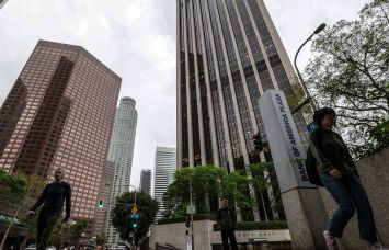 Pedestrians was passed Bank of America Plaza at 333 South Hope Street in Los Angeles.