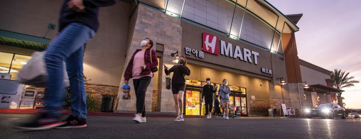 Shoppers exit the H Mart at Diamond Jamboree Shopping Center in Irvine, Calif.