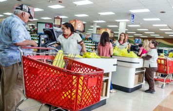 Customers check out at the registers at a Sedano's supermarket.